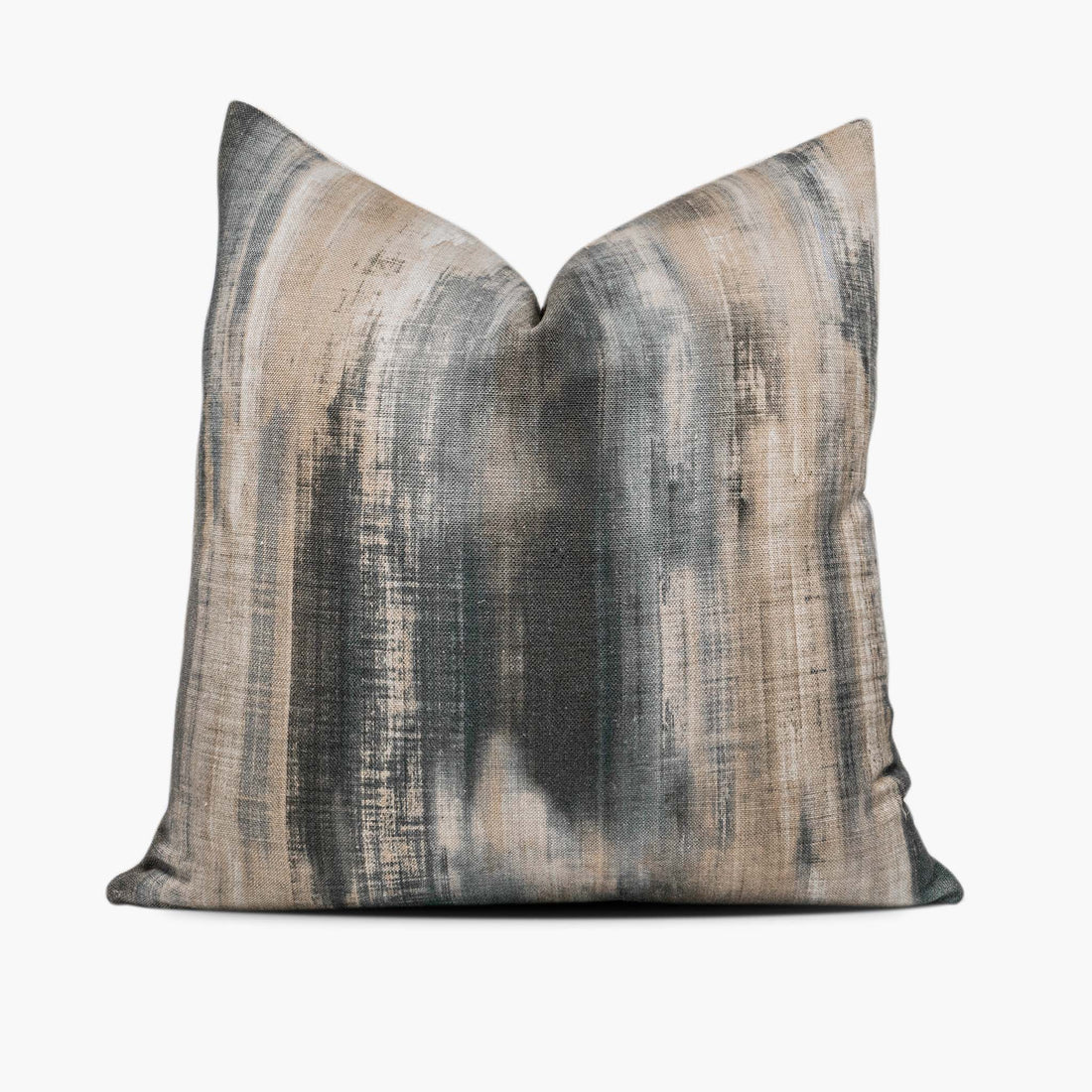 A linen-blend throw pillow with an abstract watercolor motif sits against a white background. The pillow includes shades of charcoal gray, steel blue, and beige.