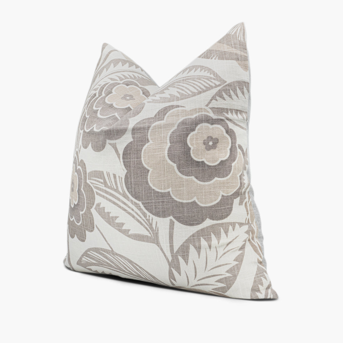 Side view of floral throw pillow with large flowers in beige, tan, and cream