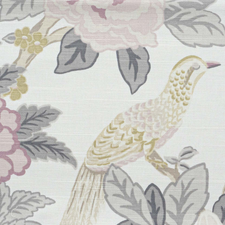 A close-up of Jaclyn Smith fabric with a bird and floral motif in pastel pink and green.