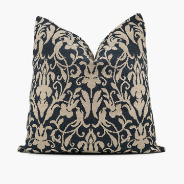 Decorative throw pillow with a black and beige damask pattern