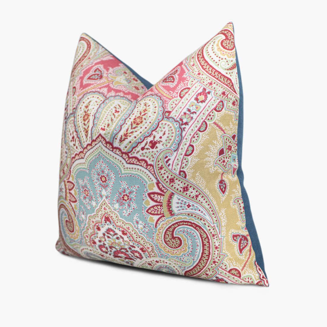 Side view of bohemian throw pillow in aqua blue, mint green, and raspberry red