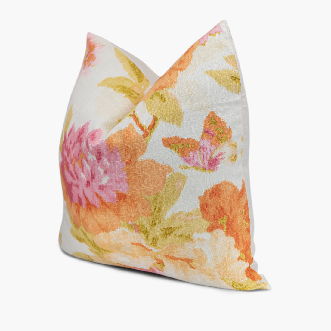 Quarter view of a floral throw pillow in white orange and pink