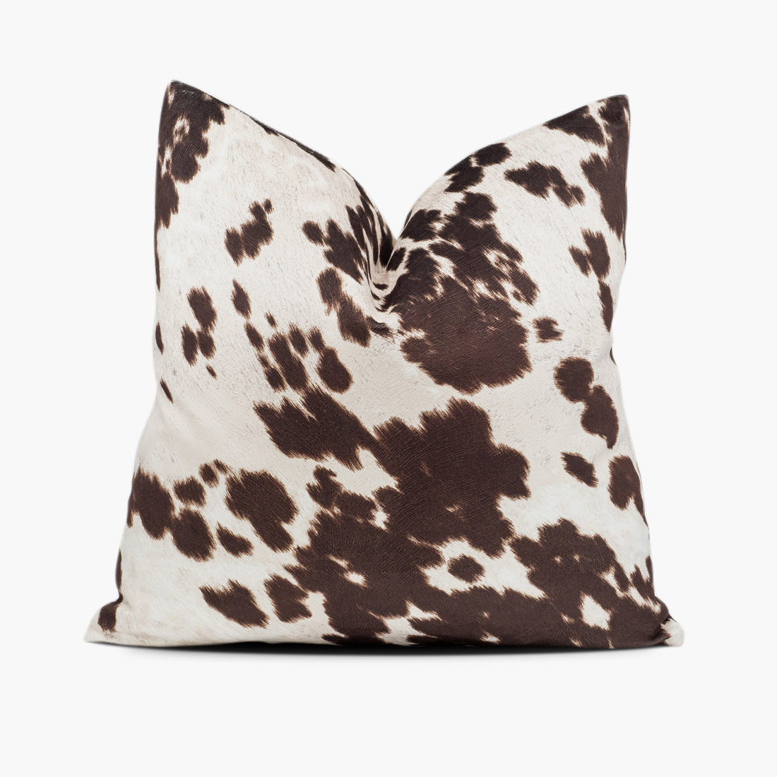 Brown and white cowhide throw pillow