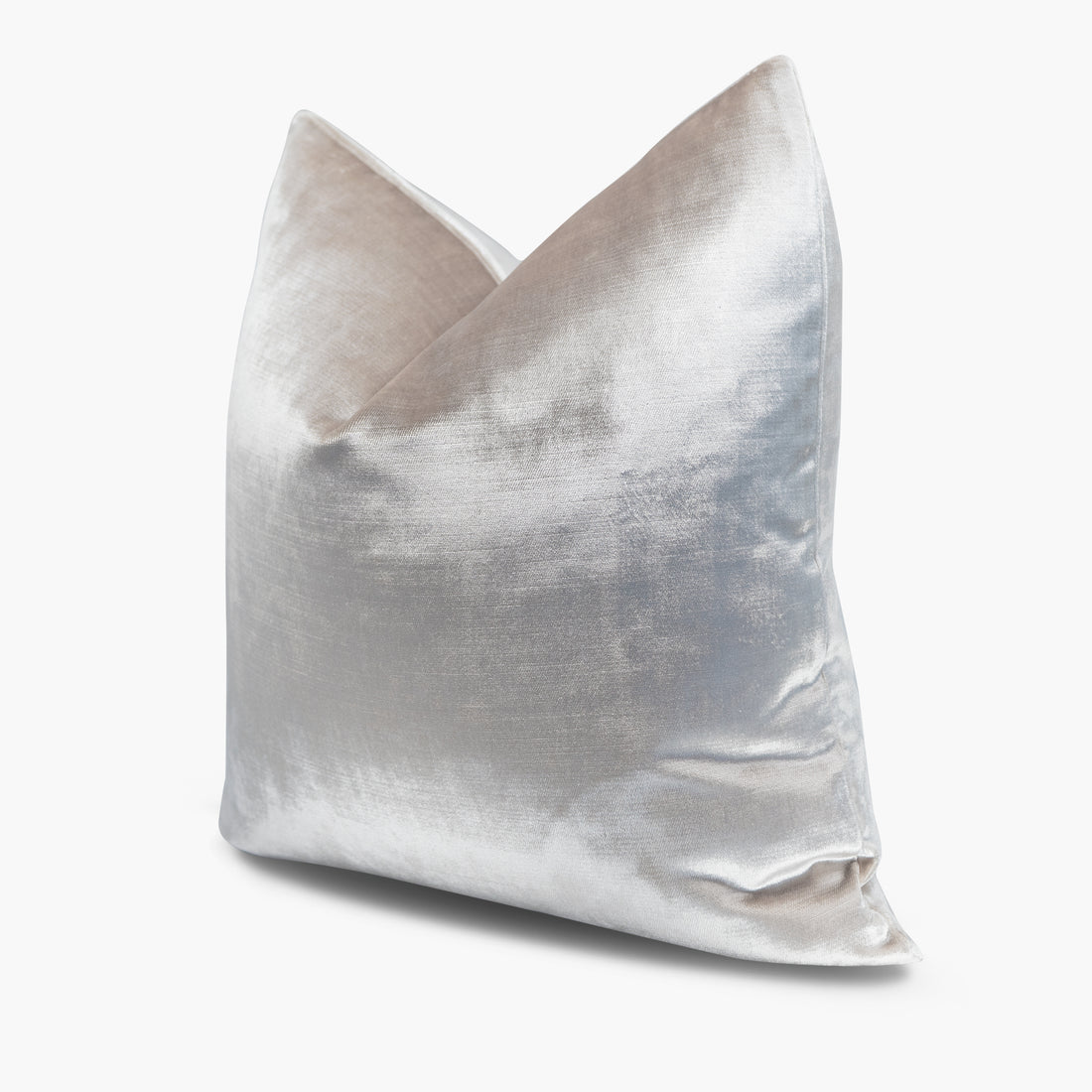 Quarter view of a velvet throw pillow in an iridescent champagne-ivory tone