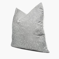 Side view of damask throw pillow cushion in silver and white