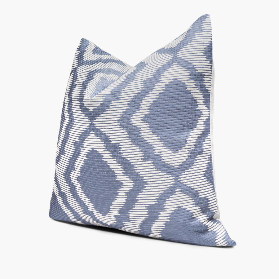 Side view of geometric throw pillow with a blue and white diamond lattice motif