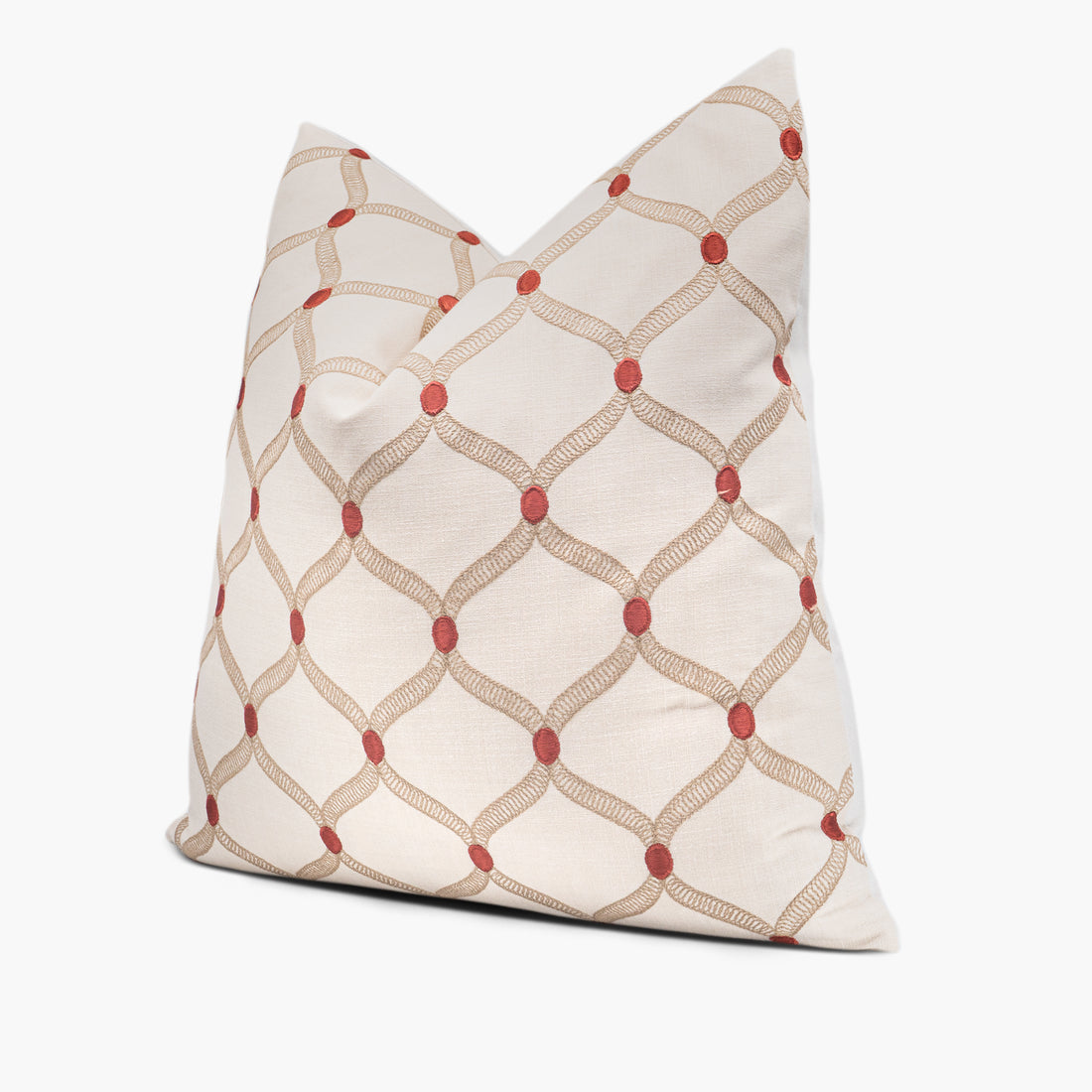 Side view of embroidered throw pillow cushion with a red dot ogee pattern