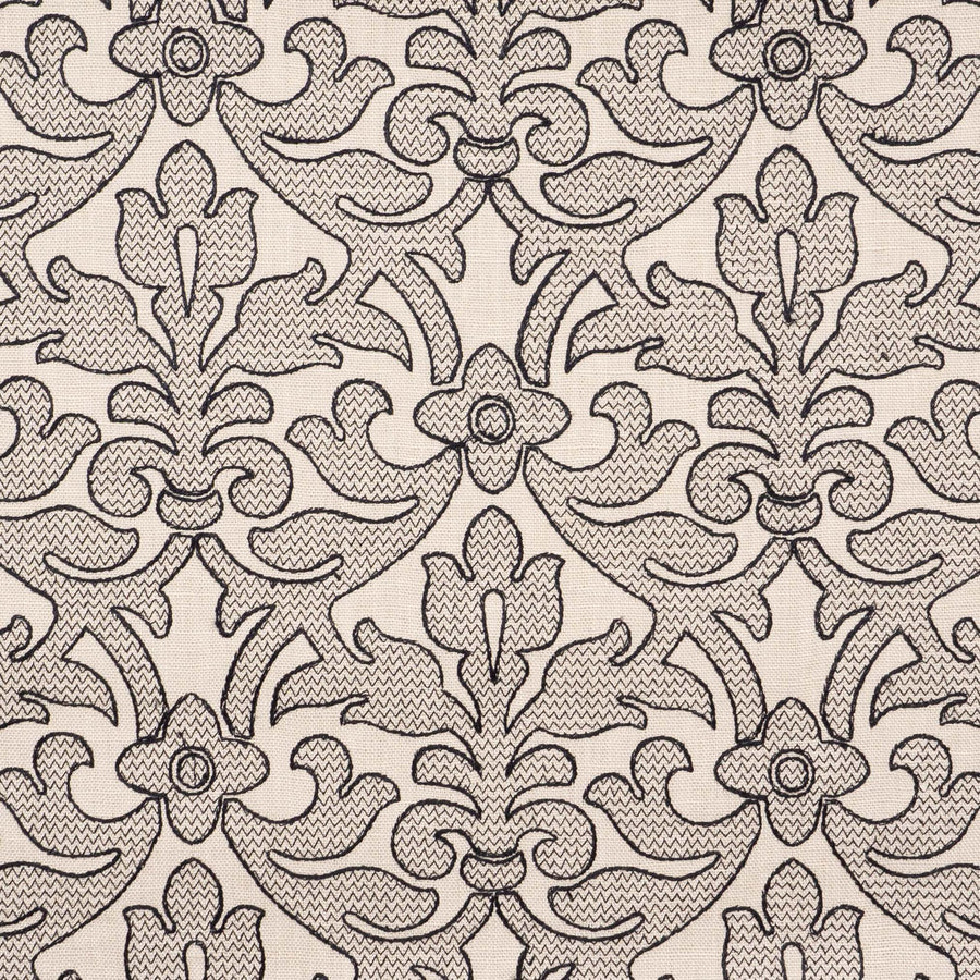 A close-up of Ersa Onyx embroidered damask fabric in black and tan.