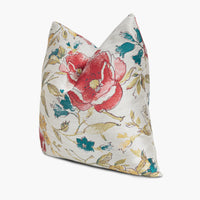 Side view of floral throw pillow in iridescent shades of red, yellow, and blue