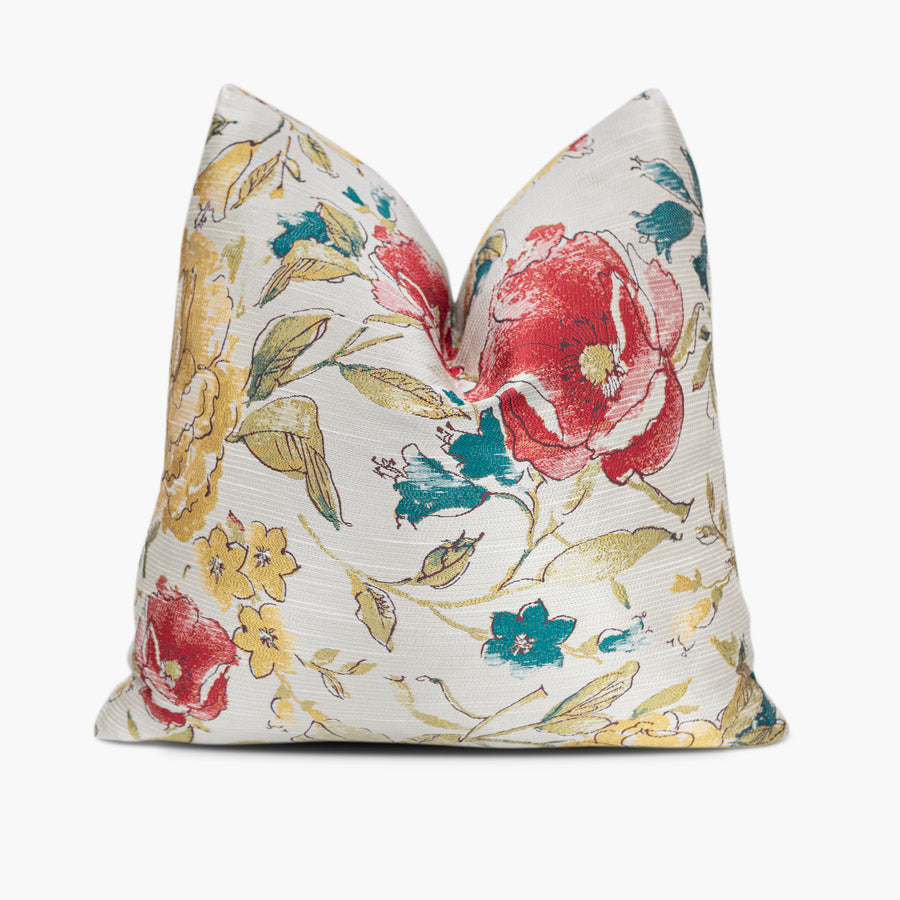 Floral throw pillow in iridescent shades of red, yellow, and blue