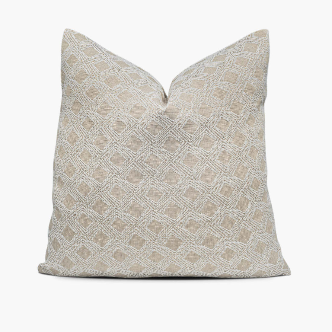 A beige throw pillow with a geometric diamond motif sits against a white background.