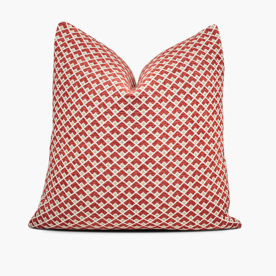 A ruby red and gold throw pillow with a geometric pattern sits against a white background.