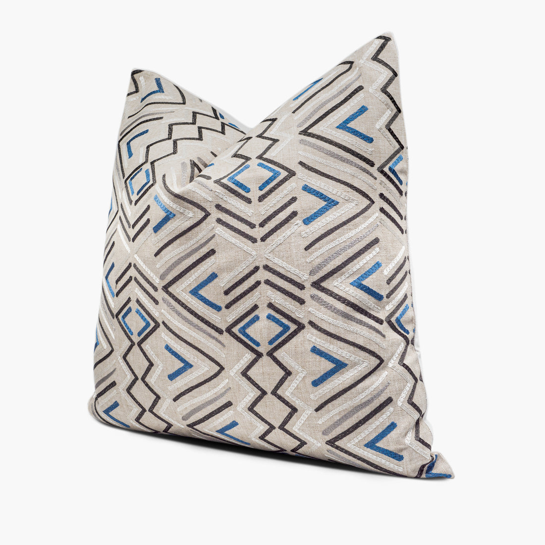 Side view of geometric tribal throw pillow cushion in beige, blue, and charcoal gray