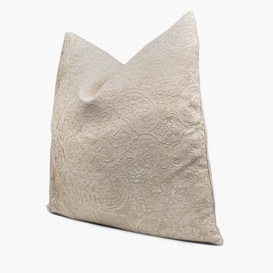 Side view of damask medallion throw pillow in vintage gold