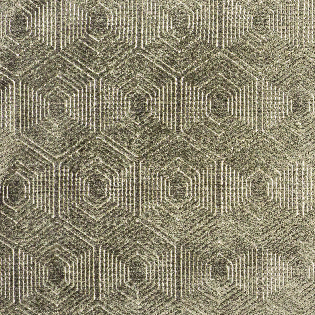 Macro shot of moss green velvet fabric with a geometric hexa-diamond motif