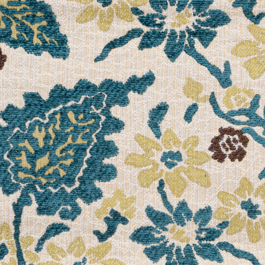 A close-up is shown of the teal and yellow Astor Place Peacock floral fabric from Kasmir.