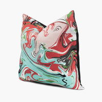 Side view of Kate Spade fabric throw pillow with marble swirl motif in red, pink, and aqua blue