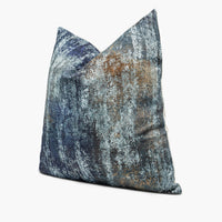 Side view of chenille throw pillow cushion with an ocean blue and bronze abstract motif