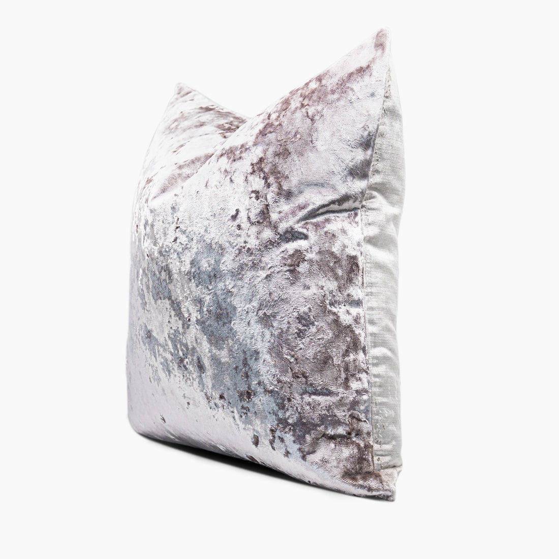 Side view of a pale purple, crushed velvet decorative throw pillow