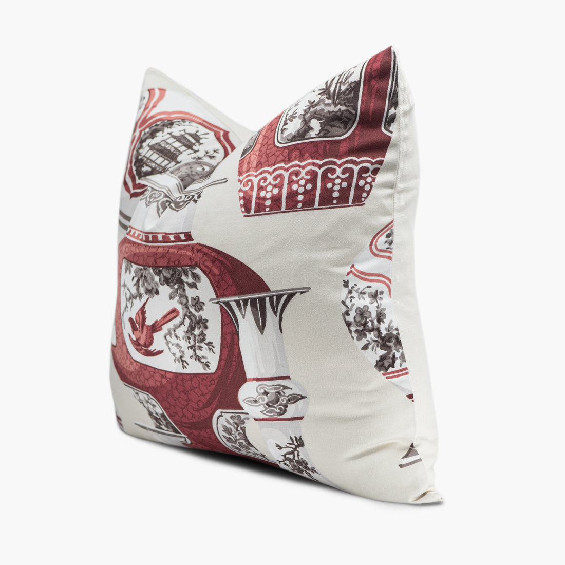 Side view of chinoiserie throw pillow with a porcelain and dove motif in white and burgundy red