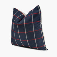 Side view of red, white, and navy blue plaid throw pillow