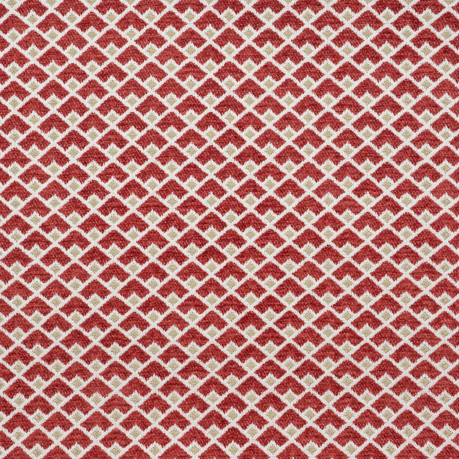 A close-up of Robert Allen Masala geometric fabric in ruby red and gold.