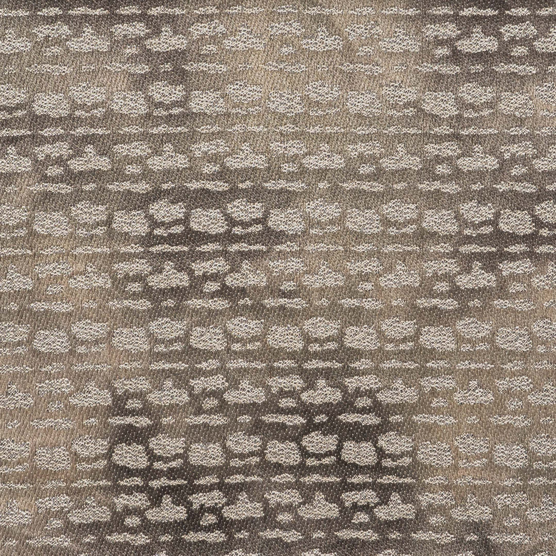 A close-up of the S. Harris Monday Muse Titan fabric. The taupe-brown fabric has abstract spots in metallic silver.