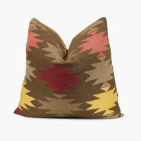 Brown outdoor throw pillow with red and yellow geometric shapes