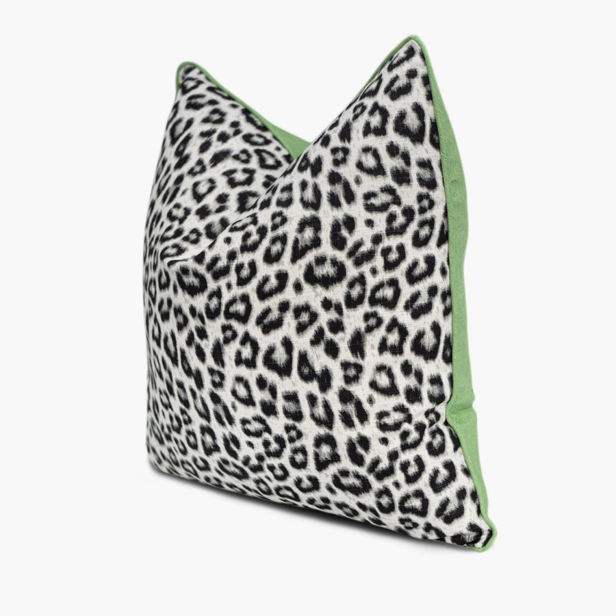 Quarter view of a snow leopard print throw pillow in black and white