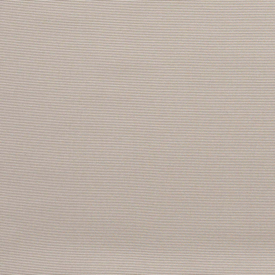 A close-up of a textured, solid beige fabric.