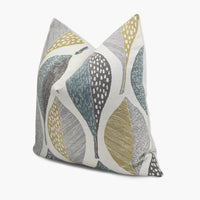 Quarter view of a teal green and gray throw pillow with a large leaf pattern