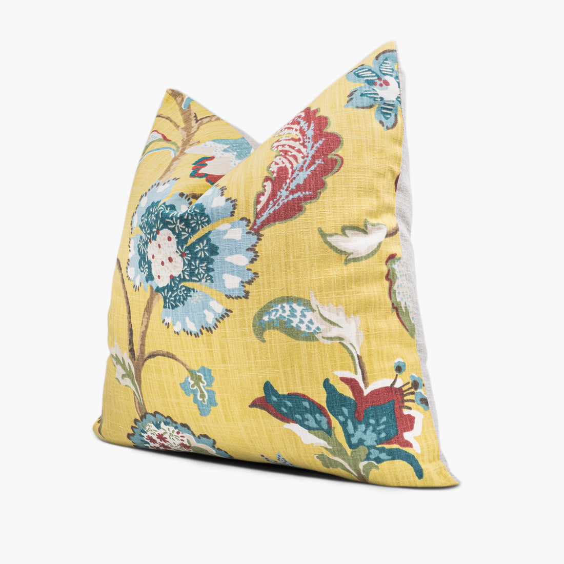 Side view of yellow floral throw pillow with blue and red flowers