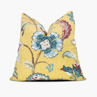 Yellow floral throw pillow with blue and red flowers